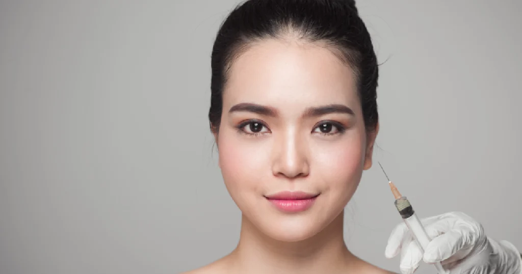 Woman receiving dermal filler injections with a syringe in Hickory, NC